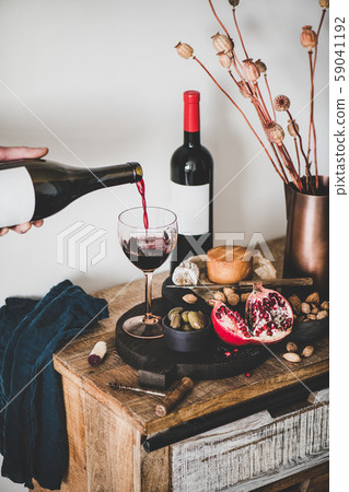Hand pouring wine from bottle and set of wine 59041192