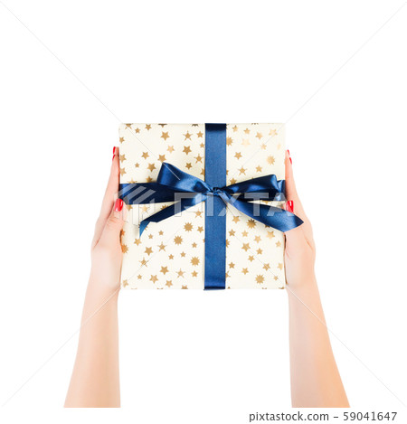 Woman hands give wrapped Christmas or other Woman hands give wrapped Christmas or other 59041647