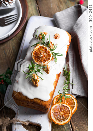 Fruit cake dusted with icing, nuts and dry orange 59042451