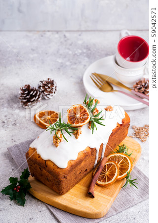 Fruit cake dusted with icing, nuts and dry orange Fruit cake dusted with icing, nuts and dry orange 59042571