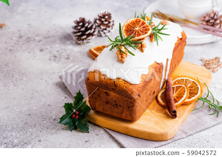 Fruit cake dusted with icing, nuts and dry orange 59042572