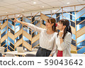 Two young women pointing towards a dream in a share office 59043642