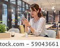 Young woman listening to music with a wireless earphone with a smile during the break 59043661