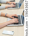 Hands and smartphones working on a computer 59043667