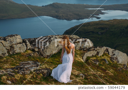 Back of girl in wedding dress in mountains Back of girl in wedding dress in mountains 59044179