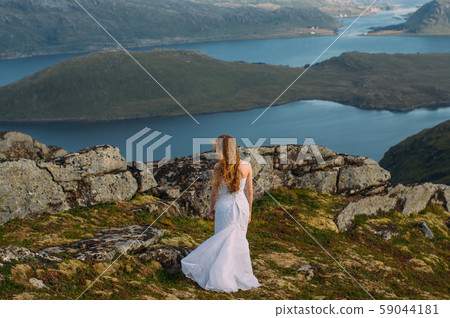 Back of girl in wedding dress in mountains  59044181