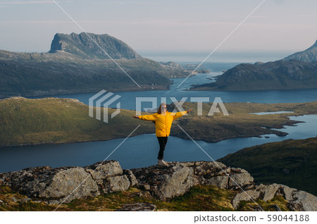 Girl in yellow jacket and hands in opposite directions Girl in yellow jacket and hands in opposite directions 59044188