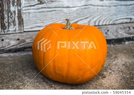 Pumpkin on front steps of home on Halloween Pumpkin on front steps of home on Halloween 59045354