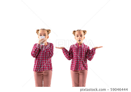 Young handsome girl arguing with herself on white studio background. Young handsome girl arguing with herself on white studio background. 59046444