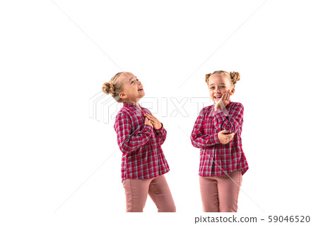 Young handsome girl arguing with herself on white studio background. Young handsome girl arguing with herself on white studio background. 59046520