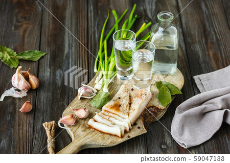 Vodka and traditional snack on wooden background Vodka and traditional snack on wooden background 59047188