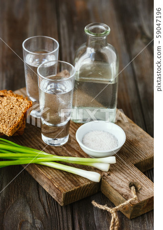 Vodka and traditional snack on wooden background 59047196