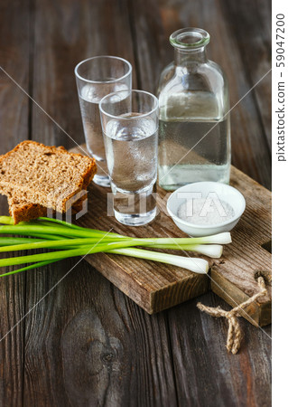 Vodka and traditional snack on wooden background 59047200