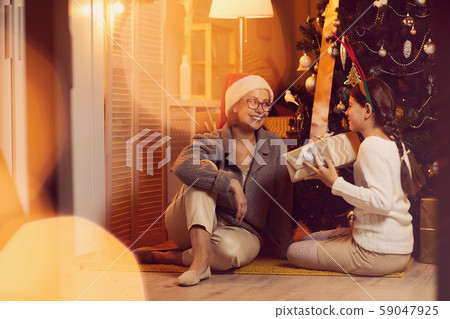 Family congratulating each other with Christmas Family congratulating each other with Christmas 59047925