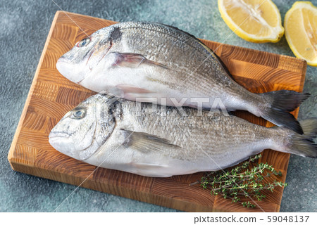 Fresh dorada on the wooden board Fresh dorada on the wooden board 59048137