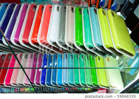 Multi-colored cases for the smartphone on a shop window. Choosing case for your smartphone. 59048330
