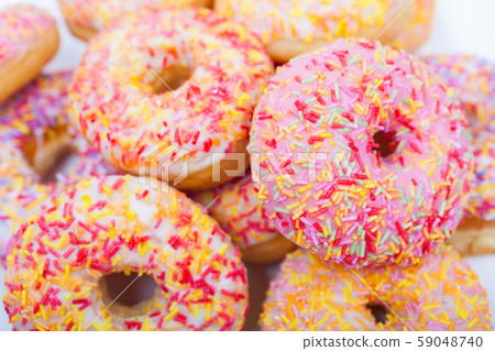 Donuts or Doughnuts With Colorful Frosting and Sprinkles 59048740