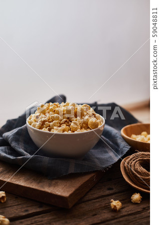 Delicious popcorn with caramel on wooden Delicious popcorn with caramel on wooden 59048811