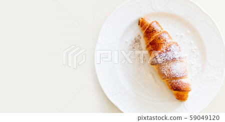 Continental breakfast background - croissant on plate. White table with copy space. Top view. 59049120