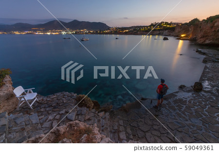 the guy on the edge of the cliff looks into the distance 59049361