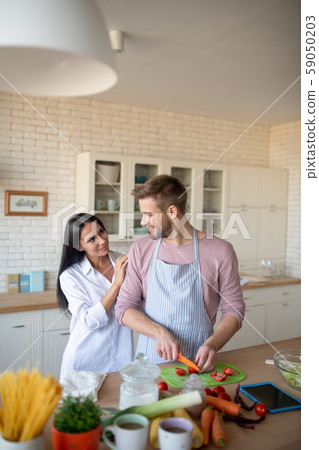 Husband cooking breakfast after watching culinary video Husband cooking breakfast after watching culinary video 59050203