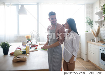 Loving caring husband cooking breakfast for his beloved 59050205