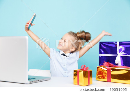 New Year blog concept. Little blogger making video on the phone about gifts isolated. 59051995