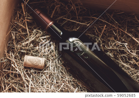 Sommelier Concept. Wine bottle on hay close-up 59052685