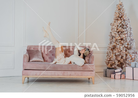 Beautiful woman is lying on the sofa. Beautiful woman is lying on the sofa. 59052956
