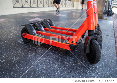 Scooters for public transport for rent in the streets of big cities 59053227
