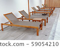 Chair loungers by the pool 59054210