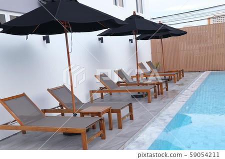 Chair loungers by the pool 59054211