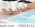 Chair loungers by the pool 59054212