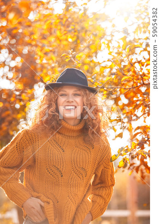 Halloween Preparaton Concept. Young woman in hat at garden laughing cheerful Halloween Preparaton Concept. Young woman in hat at garden laughing cheerful 59054382