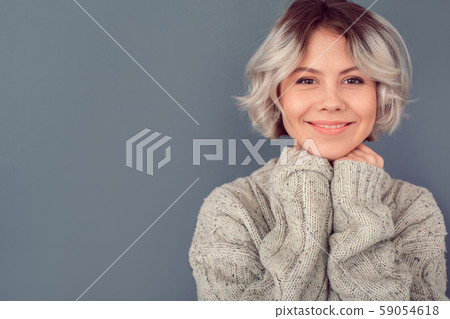 Young woman in a woolen sweater isolated on grey wall winter concept warmth Young woman in a woolen sweater isolated on grey wall winter concept warmth 59054618