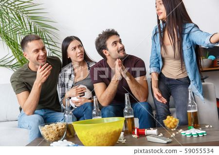 Group of friends sport fans watching football match listening to talk Group of friends sport fans watching football match listening to talk 59055534