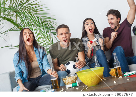Group of friends sport fans watching match screaming goal 59057677