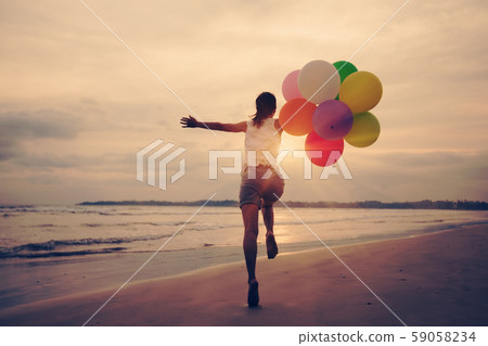 young asian woman running and jumping on seaside 59058234