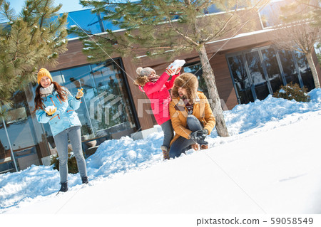 Winter vacation. Family time together outdoors playing snowballs cheerful Winter vacation. Family time together outdoors playing snowballs cheerful 59058549