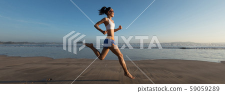 young fitness woman running at sunrise beach young fitness woman running at sunrise beach 59059289