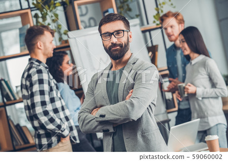 Startupers working together at office standing bearded man in glasses close-up looking camera 59060002