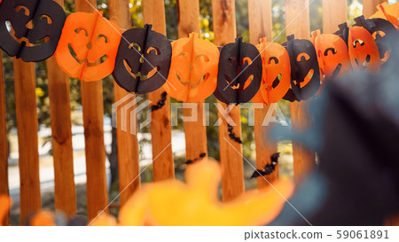 Paper garland decoration for halloween on wooden fence 59061891