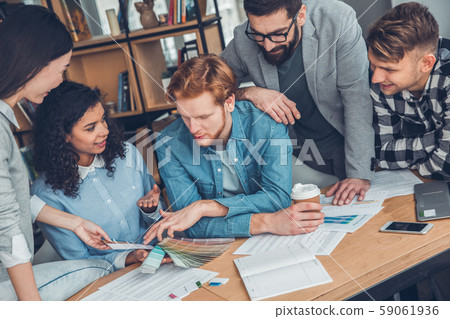 Startupers working together at office sitting discussing lively best color from palette 59061936