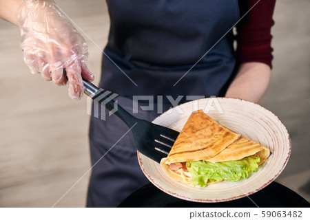 Sandwich crepe rolled up with vegetables and serving in white plate. Traditional hot breakfast food 59063482