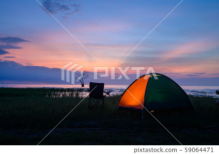 Tent and chairs by the lake Tent and chairs by the lake 59064471