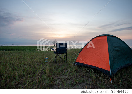 Tent and chairs by the lake Tent and chairs by the lake 59064472