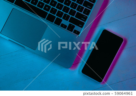 Top view of set of gadgets in purple neon light Top view of set of gadgets in purple neon light 59064961
