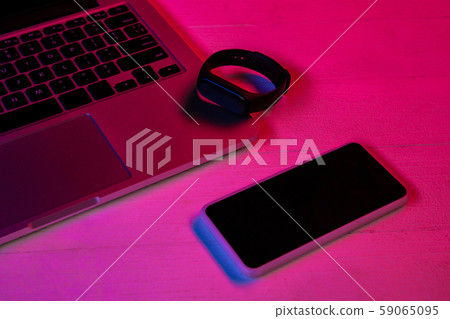 Top view of set of gadgets in purple neon light Top view of set of gadgets in purple neon light 59065095