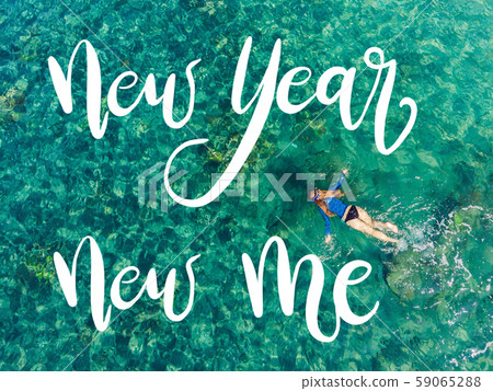 NEW YEAR NEW ME concept Happy woman in snorkeling mask dive underwater with tropical fishes in coral NEW YEAR NEW ME concept Happy woman in snorkeling mask dive underwater with tropical fishes in coral 59065288