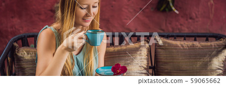 Young woman having a mediterranean breakfast seated at sofa and drinks hot aromatic coffee BANNER Young woman having a mediterranean breakfast seated at sofa and drinks hot aromatic coffee BANNER 59065662